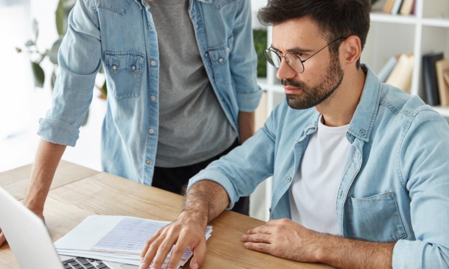 Modern workspace with financial planning materials and collaborative team environment